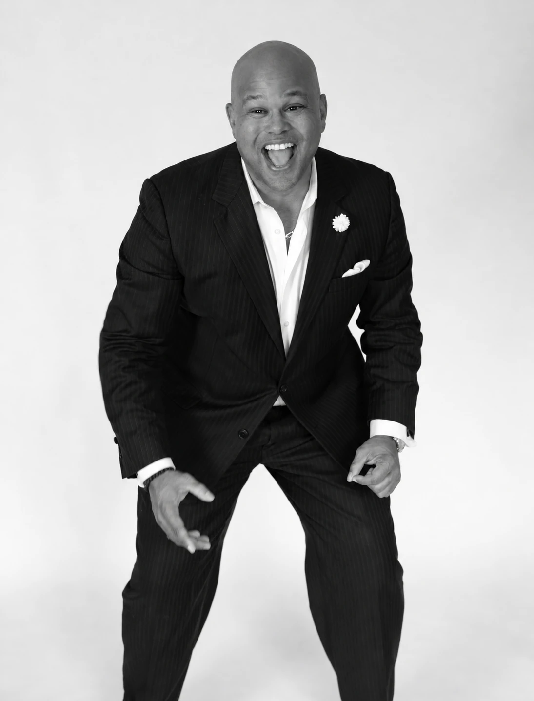 Black-and-white portrait of David Wilson laughing and leaning forward